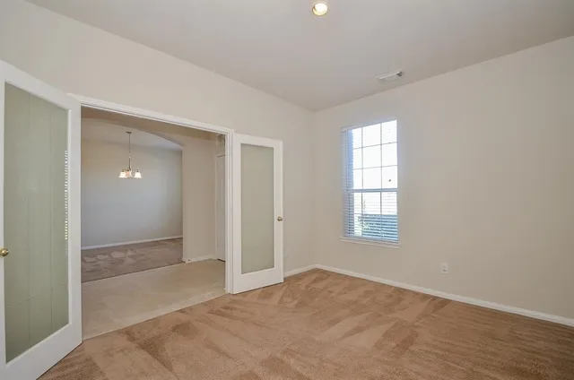 an empty room with windows and closet
