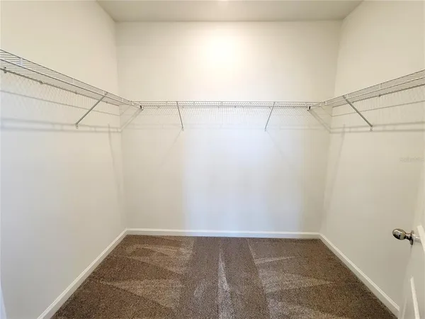 a large bathroom with a sink mirror and a bath tub