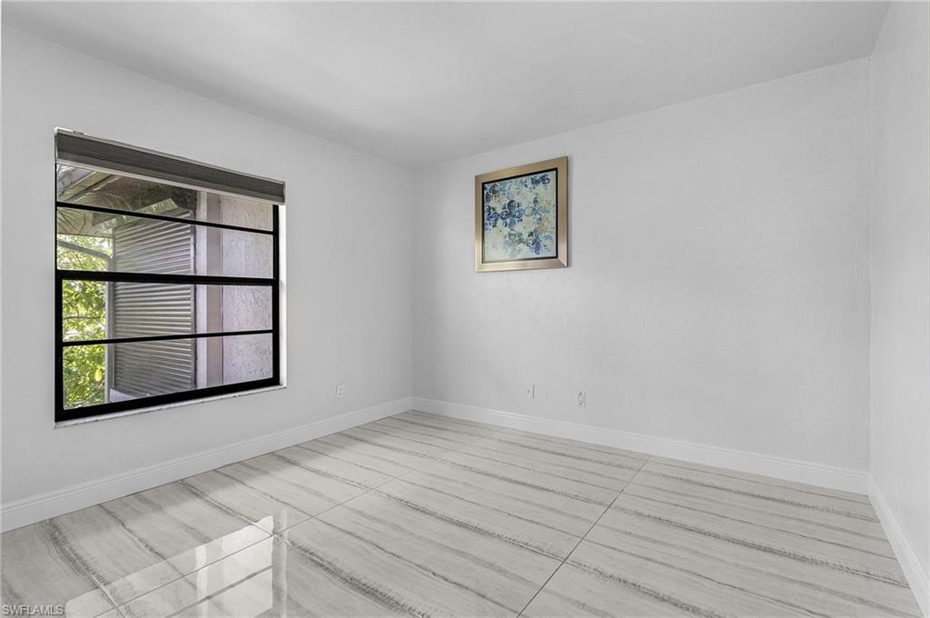 1765 Courtyard Way, Unit C202 Naples, FL 34112 - Photo 11 of 25 Empty room featuring baseboards