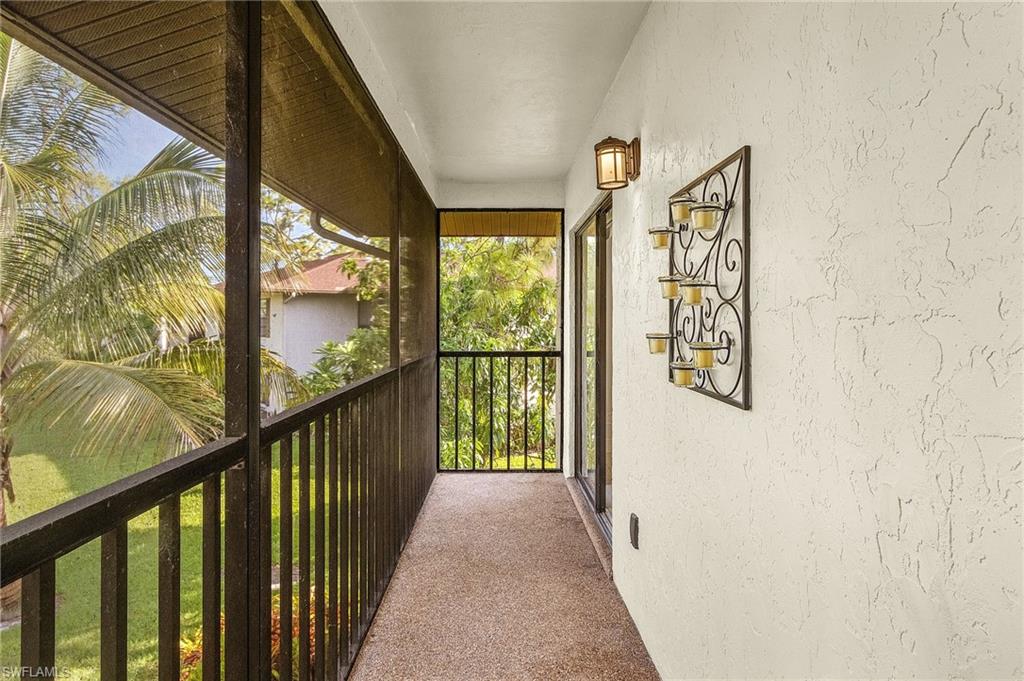 1765 Courtyard Way, Unit C202 Naples, FL 34112 - Photo 17 of 25 Balcony featuring a sunroom
