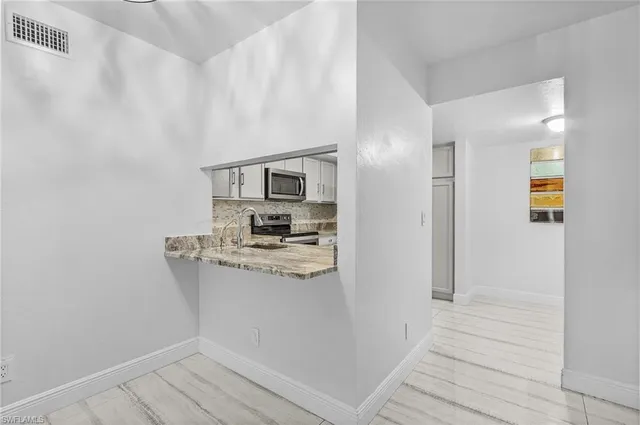 a kitchen with stainless steel appliances a refrigerator and a stove