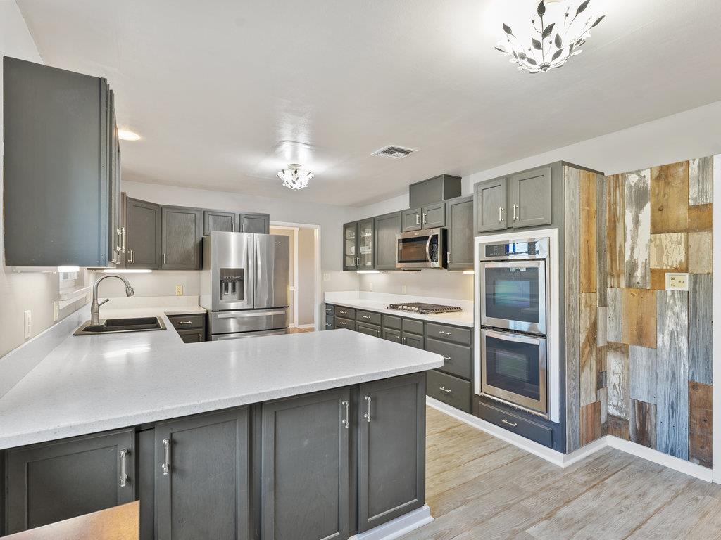 63155 Argyle Road King City, CA 93930 - Photo 14 of 46 a kitchen with stainless steel appliances a sink stove and refrigerator