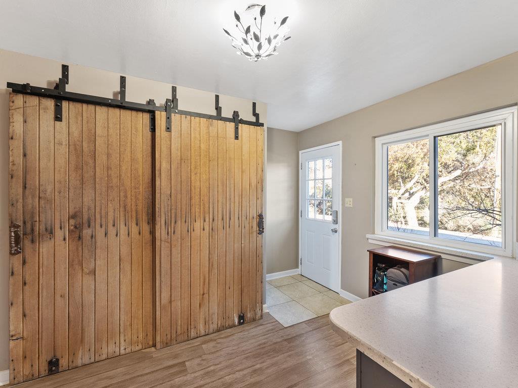 63155 Argyle Road King City, CA 93930 - Photo 24 of 46 a view of a livingroom with wooden floor a ceiling fan and windows