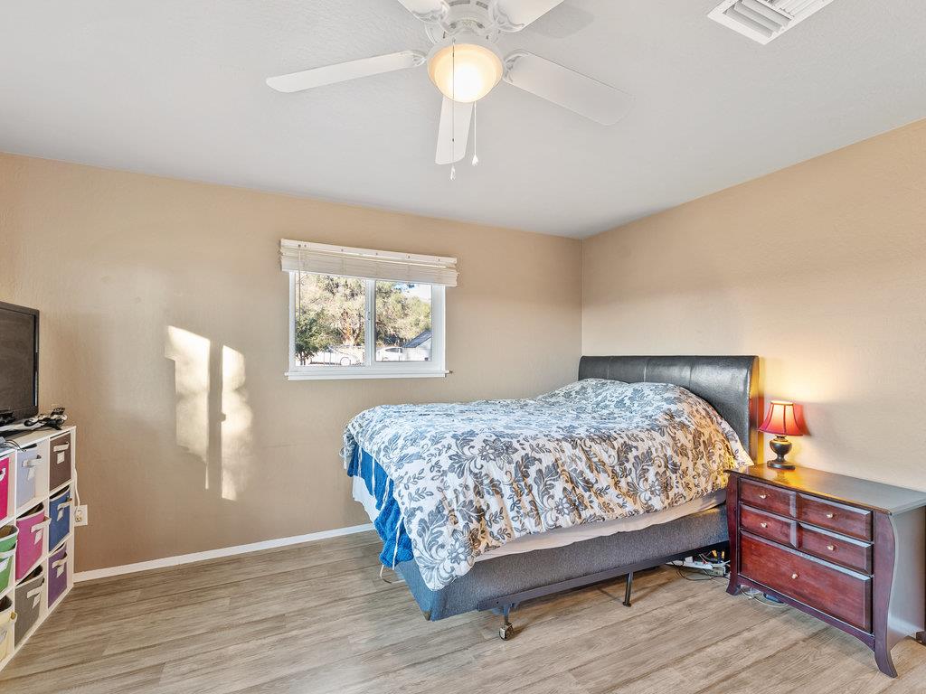 63155 Argyle Road King City, CA 93930 - Photo 28 of 46 a bedroom with a bed and a chandelier