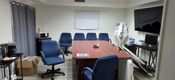 a view of a workspace with furniture and a window