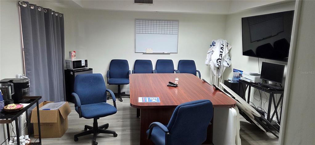 4936 Southwest 91 Terrace Gainesville, FL 32608 - Photo 4 of 11 a view of a workspace with furniture and a window