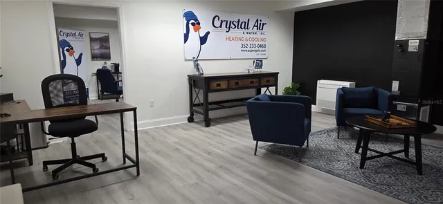 a view of a workspace with furniture and a potted plant