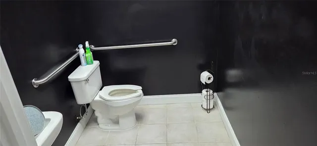 a white toilet sitting next to a small bathroom