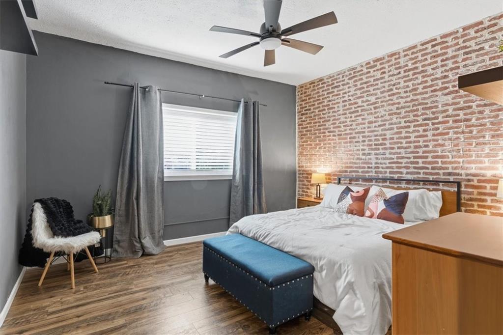 343 8th Street Northeast, Unit T1 Atlanta, GA 30309 - Photo 17 of 33 a bedroom with a bed and chair