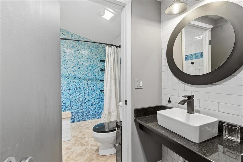 343 8th Street Northeast, Unit T1 Atlanta, GA 30309 - Photo 22 of 33 a bathroom with a sink a toilet and a mirror