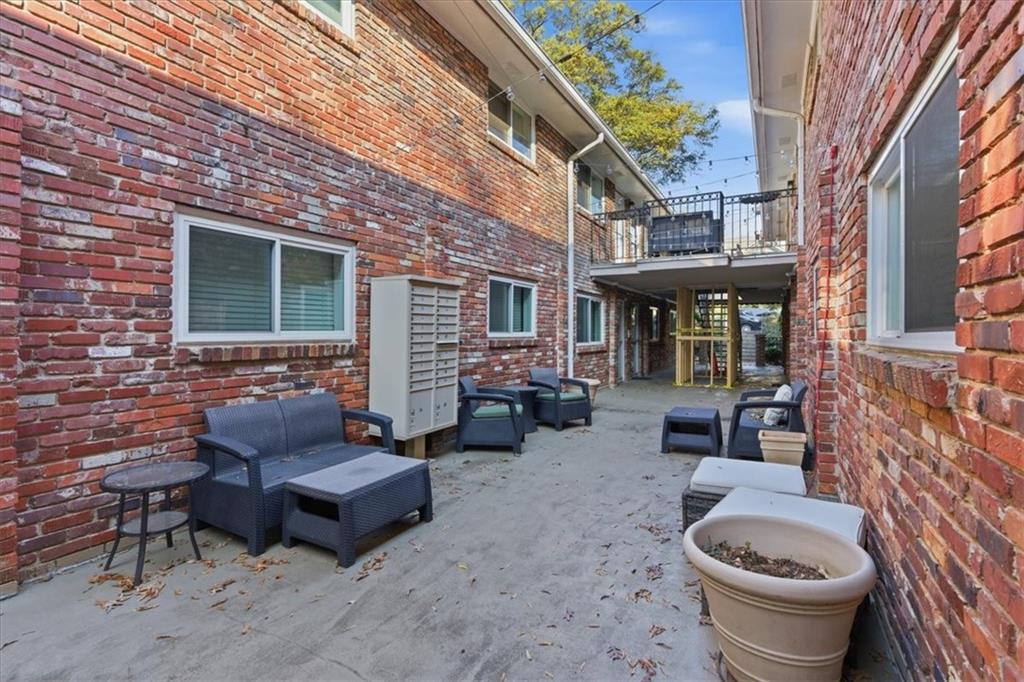 343 8th Street Northeast, Unit T1 Atlanta, GA 30309 - Photo 25 of 33 a front view of a house with outdoor seating