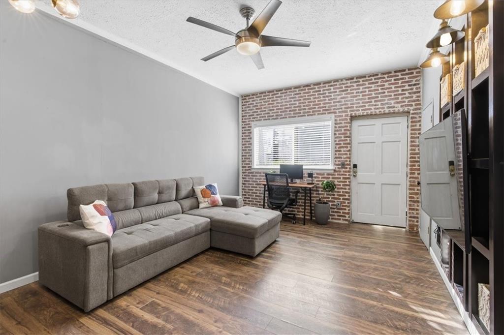 343 8th Street Northeast, Unit T1 Atlanta, GA 30309 - Photo 8 of 33 a living room with furniture and a flat screen tv
