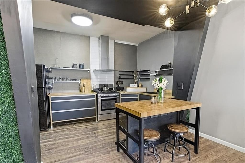 343 8th Street Northeast, Unit T1 Atlanta, GA 30309 - Photo 10 of 33 a kitchen with a table and chairs in it