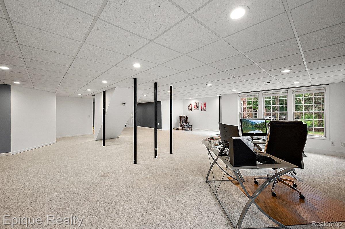 1909 Catlin Drive Rochester, MI 48306 - Photo 48 of 76 Expansive carpeted area featuring multiple large windows, recessed ceiling lights, and a drop ceiling
