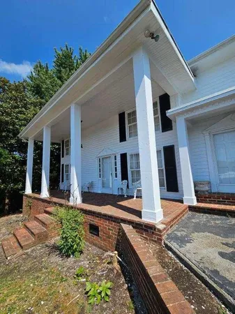 a front view of a house with garden