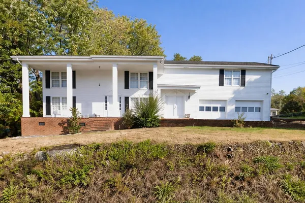 a view of a house with swimming pool and sitting area