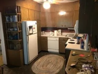 a kitchen with a sink appliances and cabinets