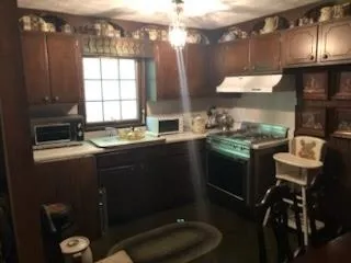 a kitchen with a sink appliances and cabinets