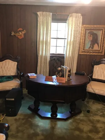 a room with a table chairs and a window