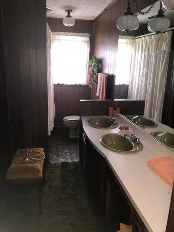 a kitchen with a sink and a stove next to a window