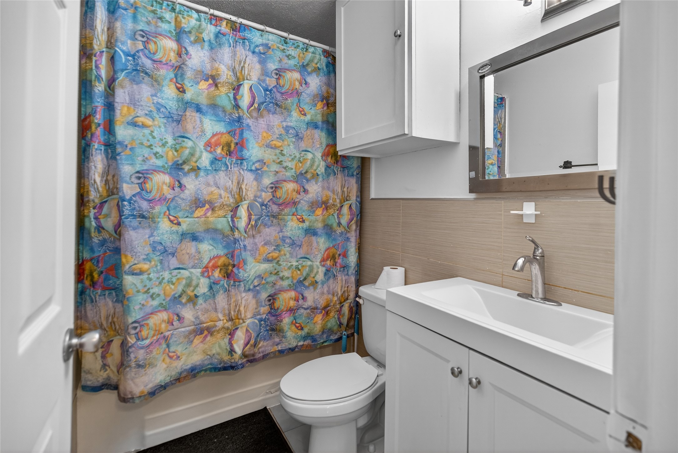 1400 Braes Ridge Drive, Unit B Austin, TX 78723 - Photo 12 of 16 Bathroom featuring vanity, tile walls, and shower / bath combo