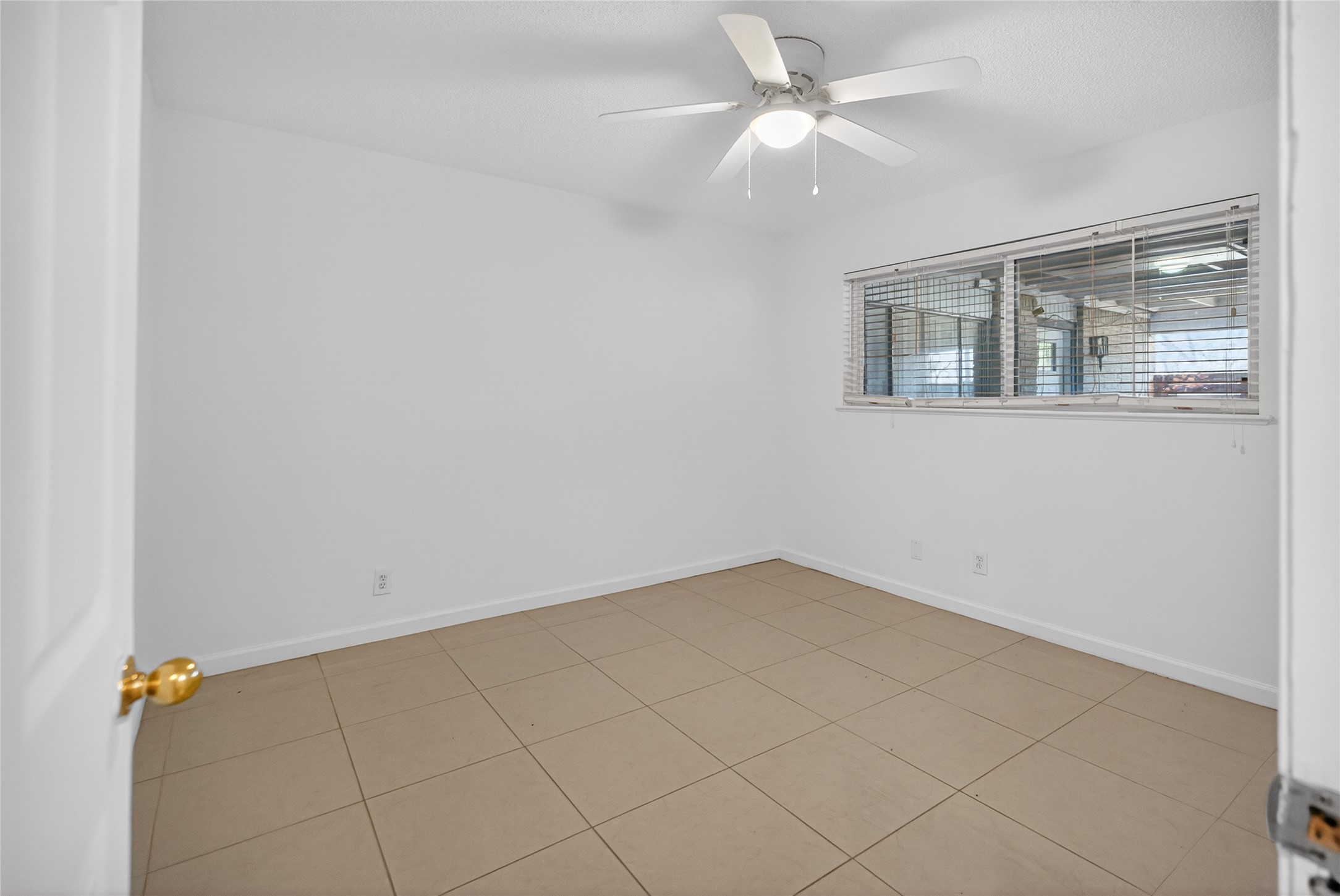 1400 Braes Ridge Drive, Unit B Austin, TX 78723 - Photo 16 of 16 Bedroom with light tile patterned floors and a ceiling fan