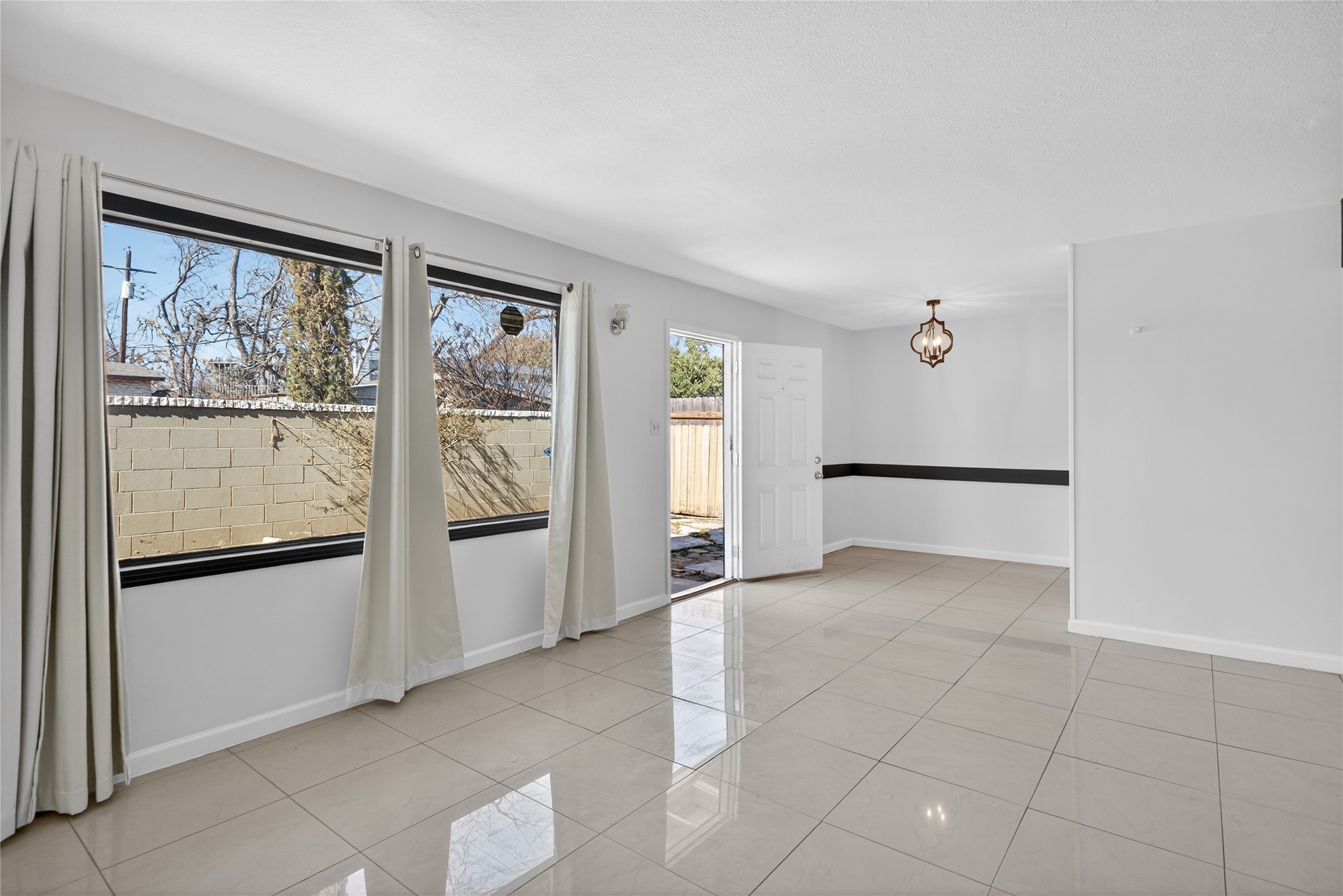 1400 Braes Ridge Drive, Unit B Austin, TX 78723 - Photo 5 of 16 Primary living area featuring light tile patterned floors and suspended lighting