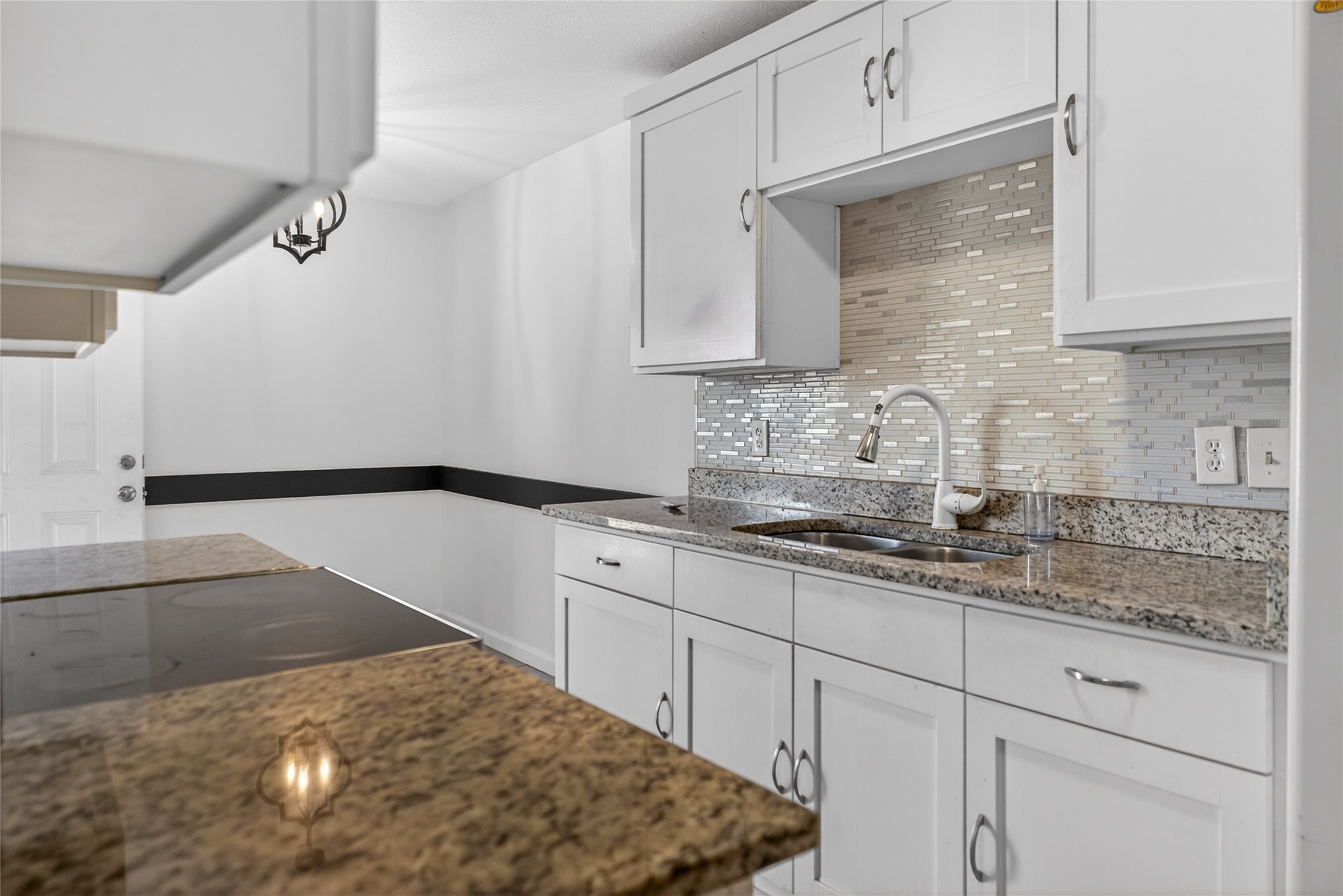 1400 Braes Ridge Drive, Unit B Austin, TX 78723 - Photo 8 of 16 Kitchen featuring dark stone counters, white cabinets, and decorative backsplash