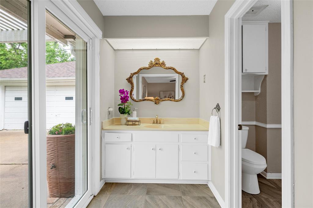3301 Loma Vista Drive Waco, TX 76708 - Photo 12 of 29 White vanity with gold-tone hardware and a light-colored countertop