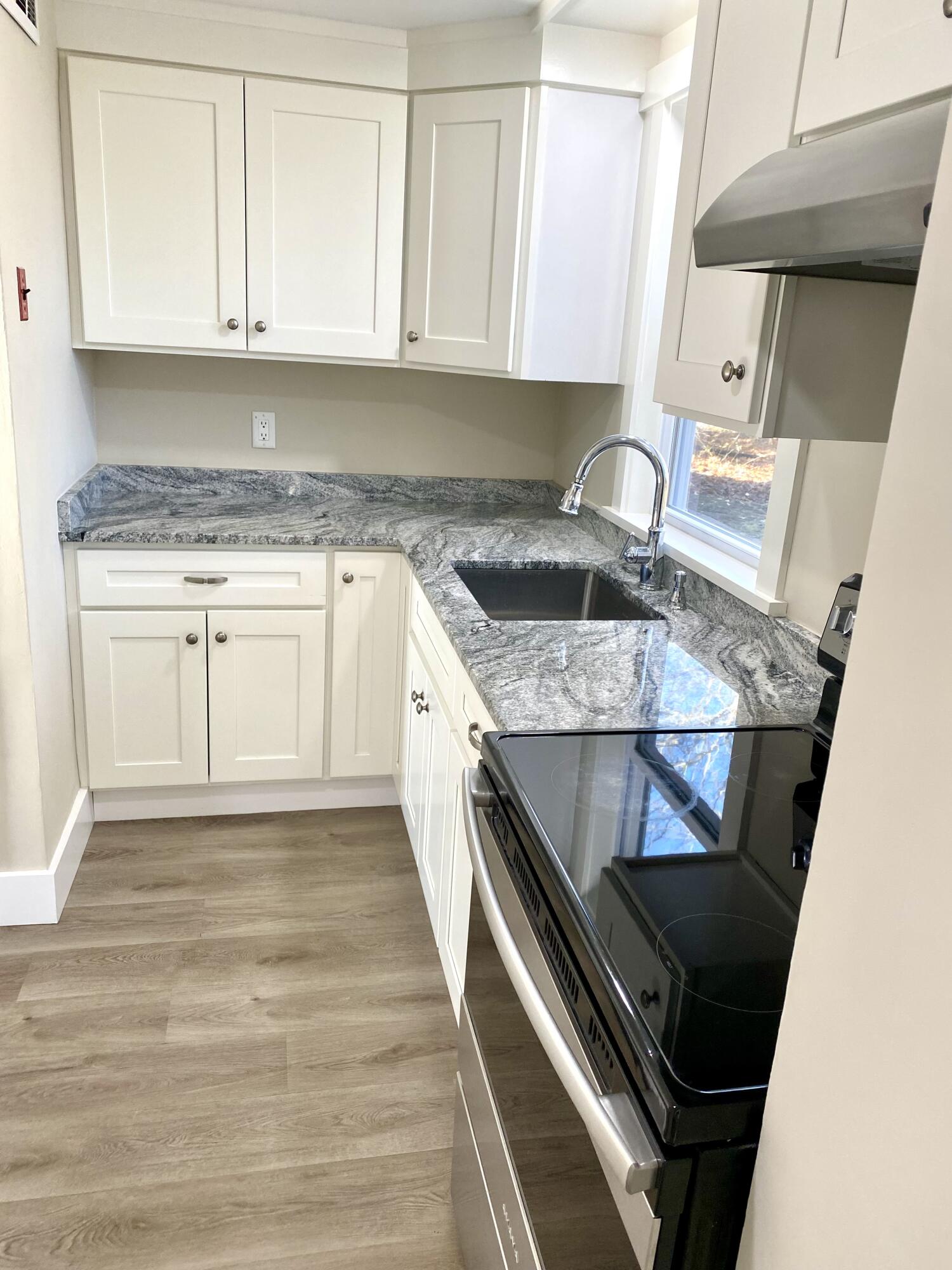 5 General Patton Drive Hyannis, MA 02601 - Photo 47 of 66 a kitchen with granite countertop a stove sink and cabinets