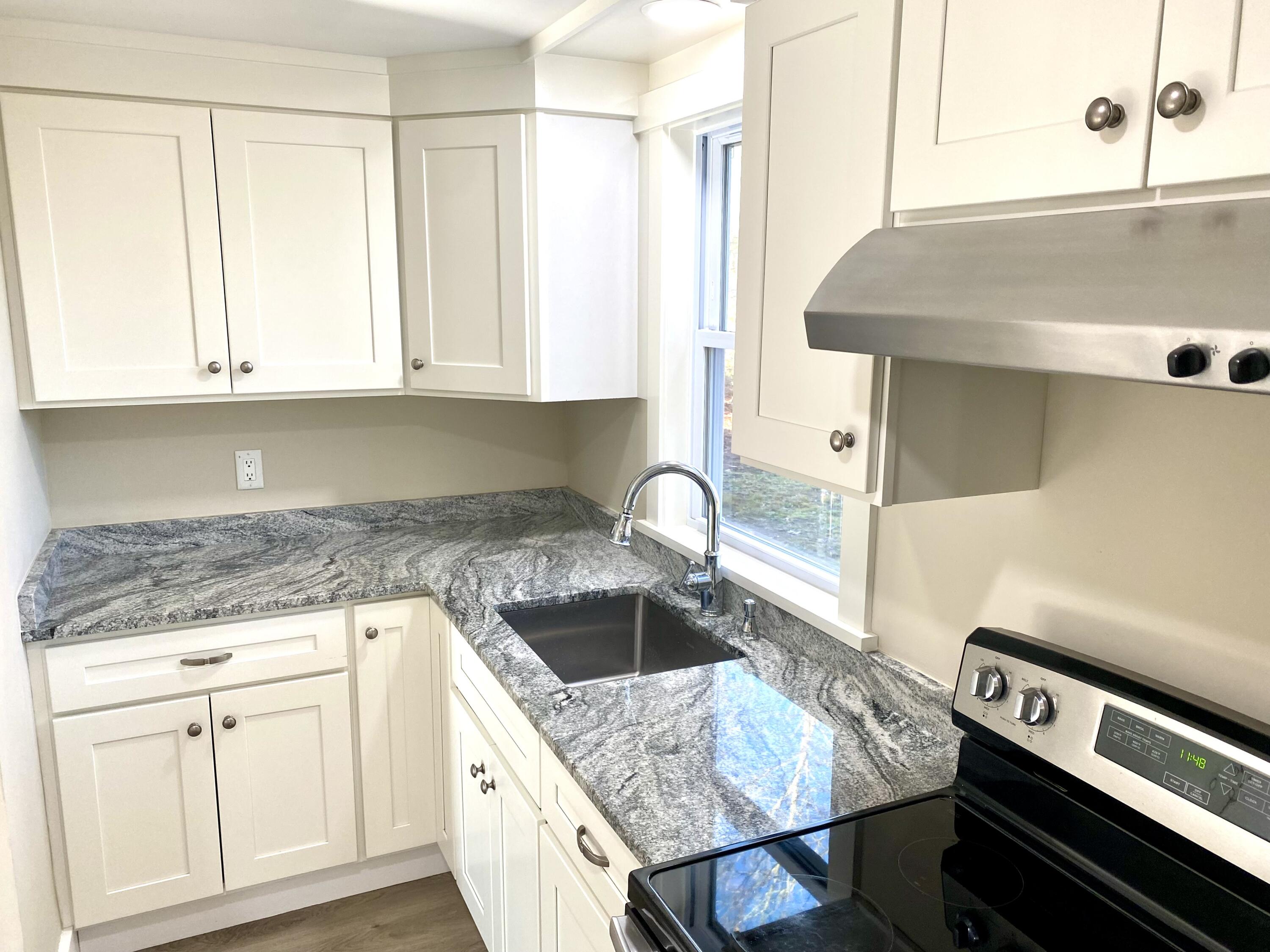 5 General Patton Drive Hyannis, MA 02601 - Photo 48 of 66 a kitchen with granite countertop a sink a stove and cabinets