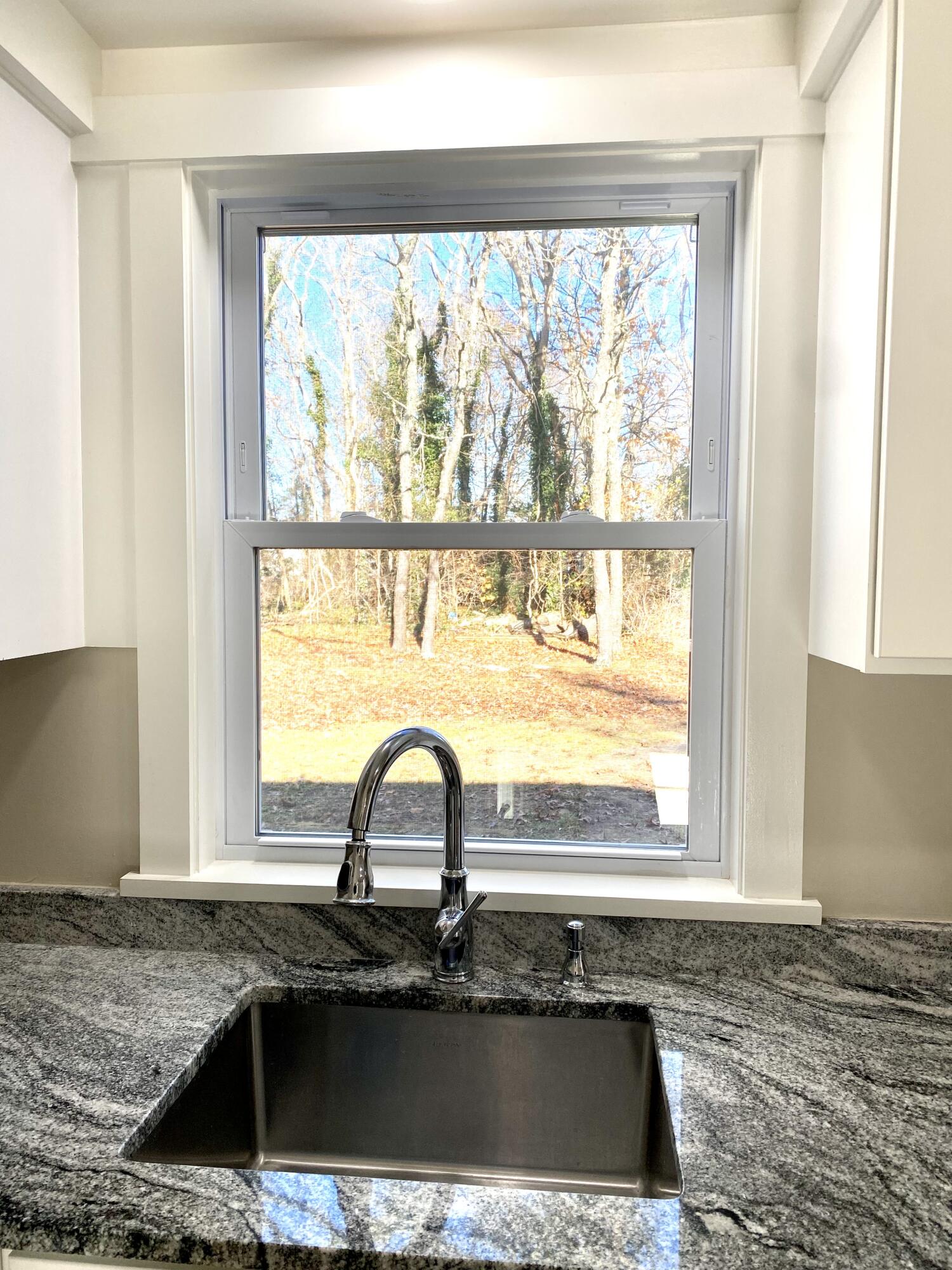 5 General Patton Drive Hyannis, MA 02601 - Photo 5 of 66 a kitchen with granite countertop a sink and a window