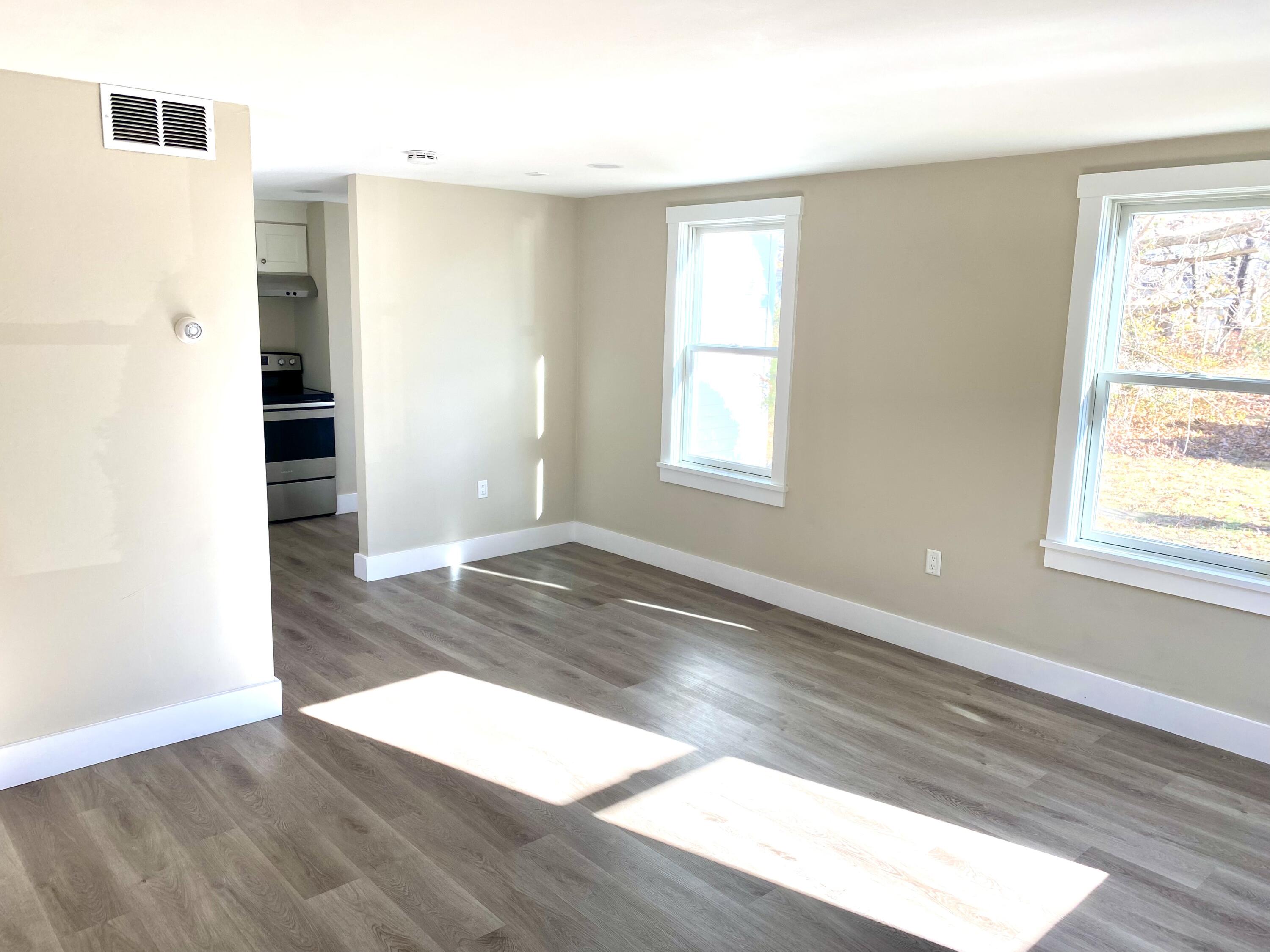 5 General Patton Drive Hyannis, MA 02601 - Photo 52 of 66 an empty room with wooden floor and windows