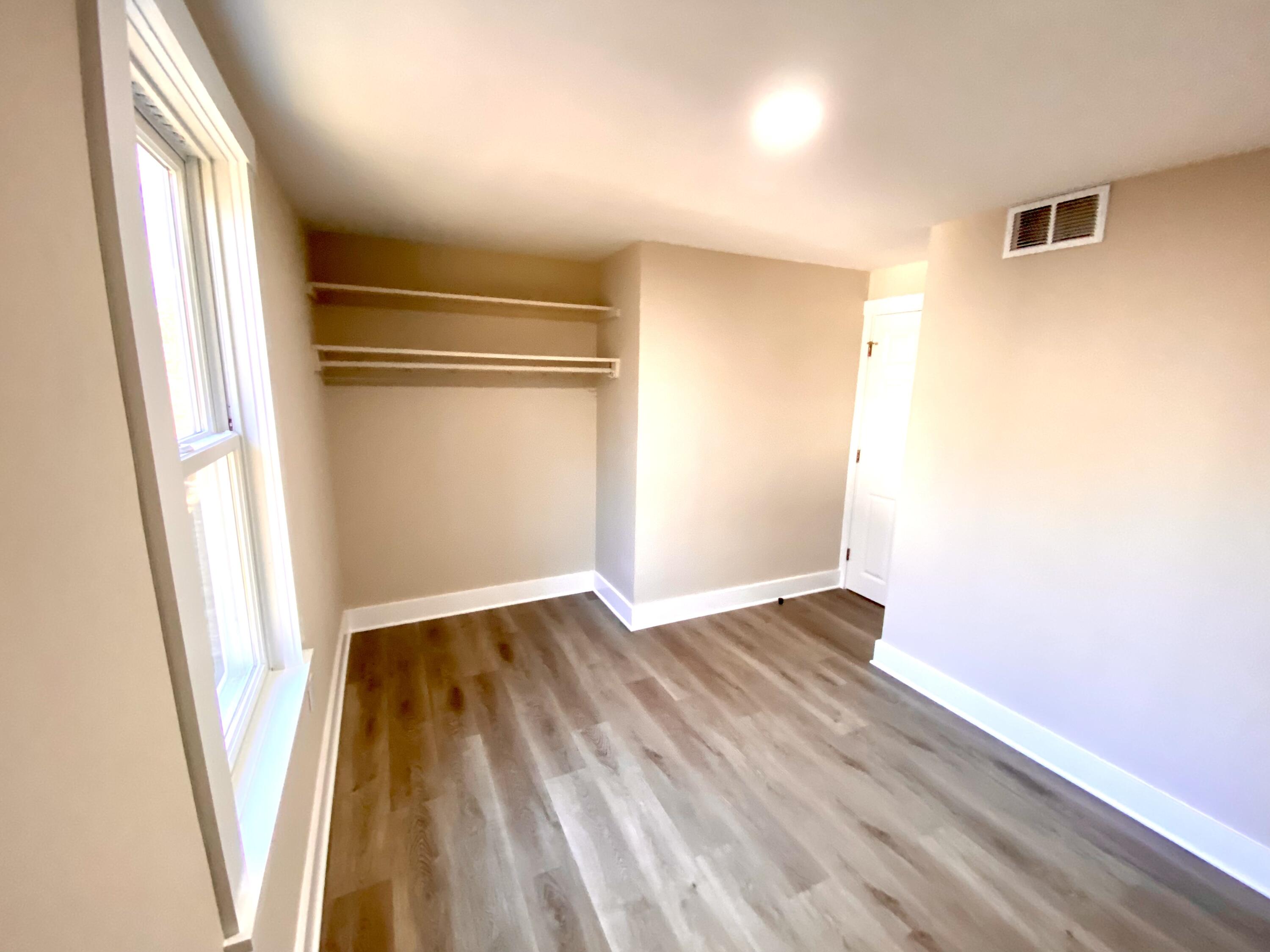 5 General Patton Drive Hyannis, MA 02601 - Photo 59 of 66 an empty room with wooden floor and windows