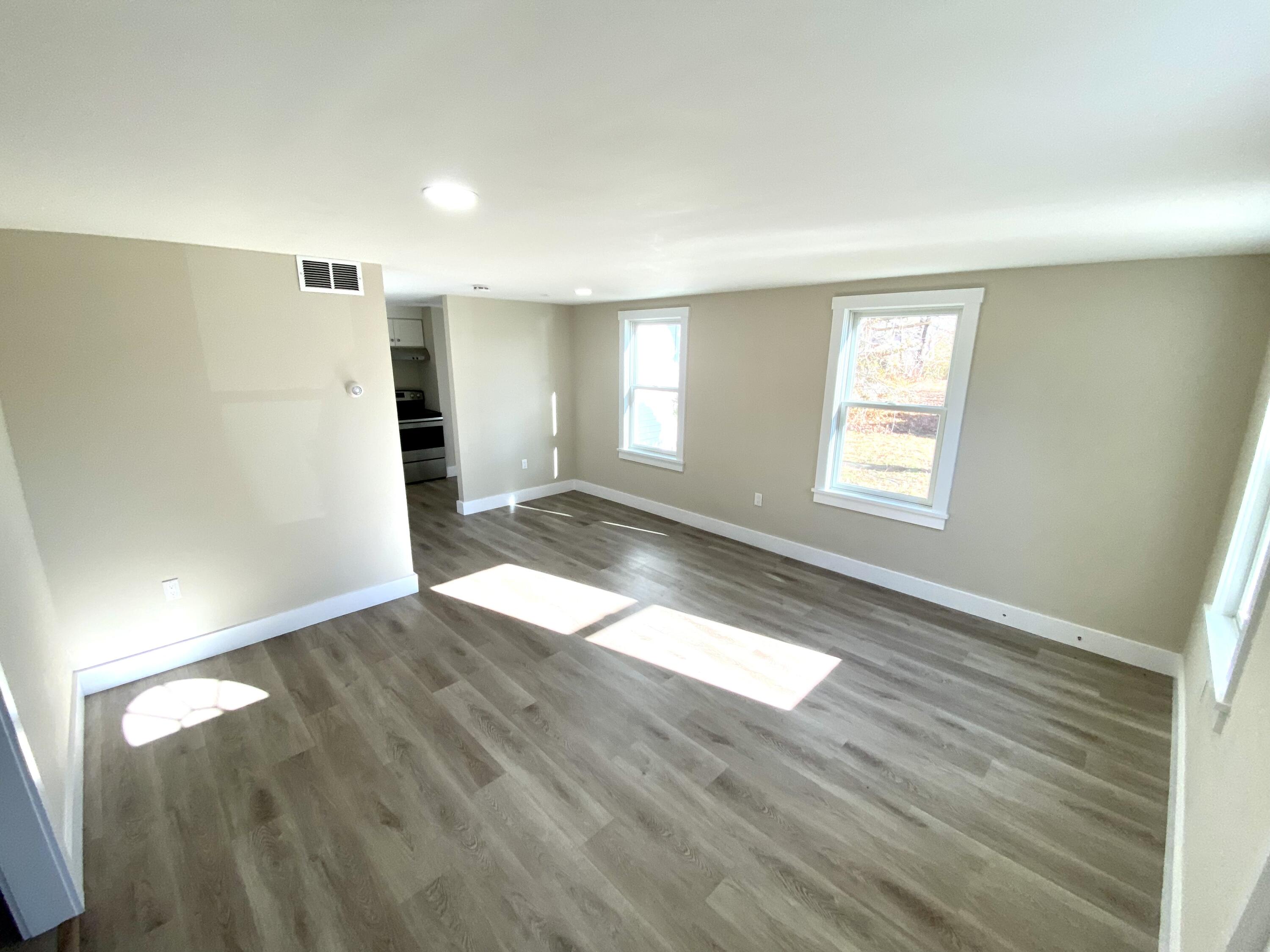 5 General Patton Drive Hyannis, MA 02601 - Photo 10 of 66 an empty room with wooden floor and windows