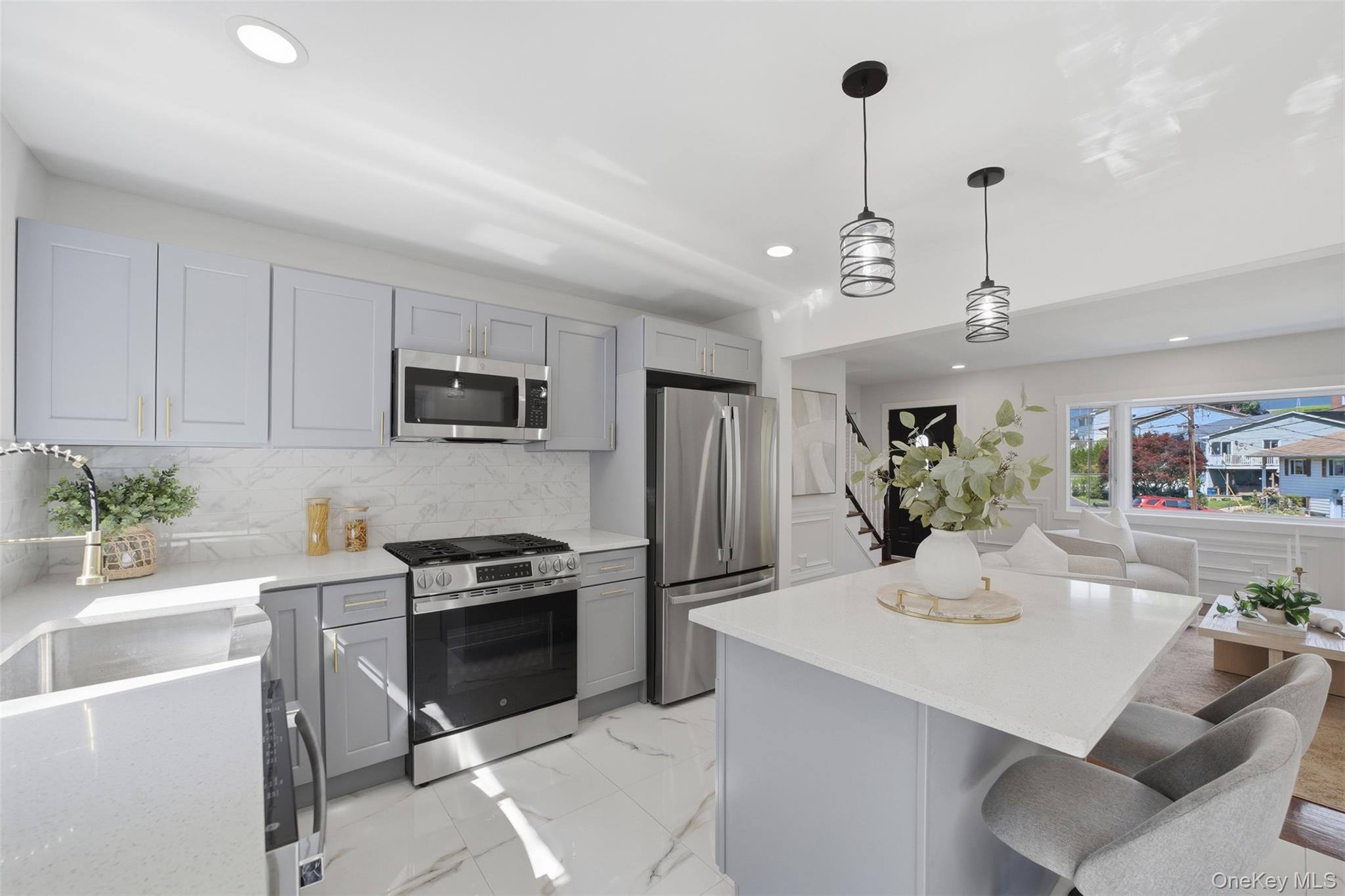 24 Fuller Road Ossining, NY 10562 - Photo 11 of 48 a kitchen with granite countertop a sink stainless steel appliances and white cabinets