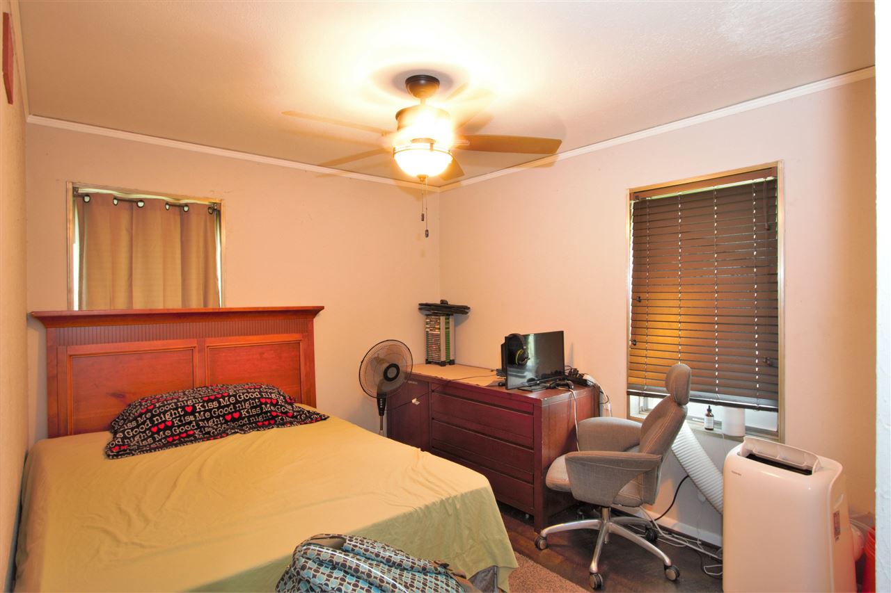 1783 Sea Isle Road Memphis, TN 38117 - Photo 12 of 20 a bedroom with a bed and a chandelier