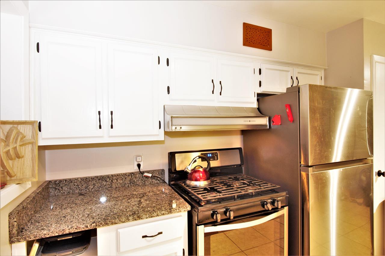 1783 Sea Isle Road Memphis, TN 38117 - Photo 5 of 20 a kitchen with stainless steel appliances granite countertop a stove and a refrigerator