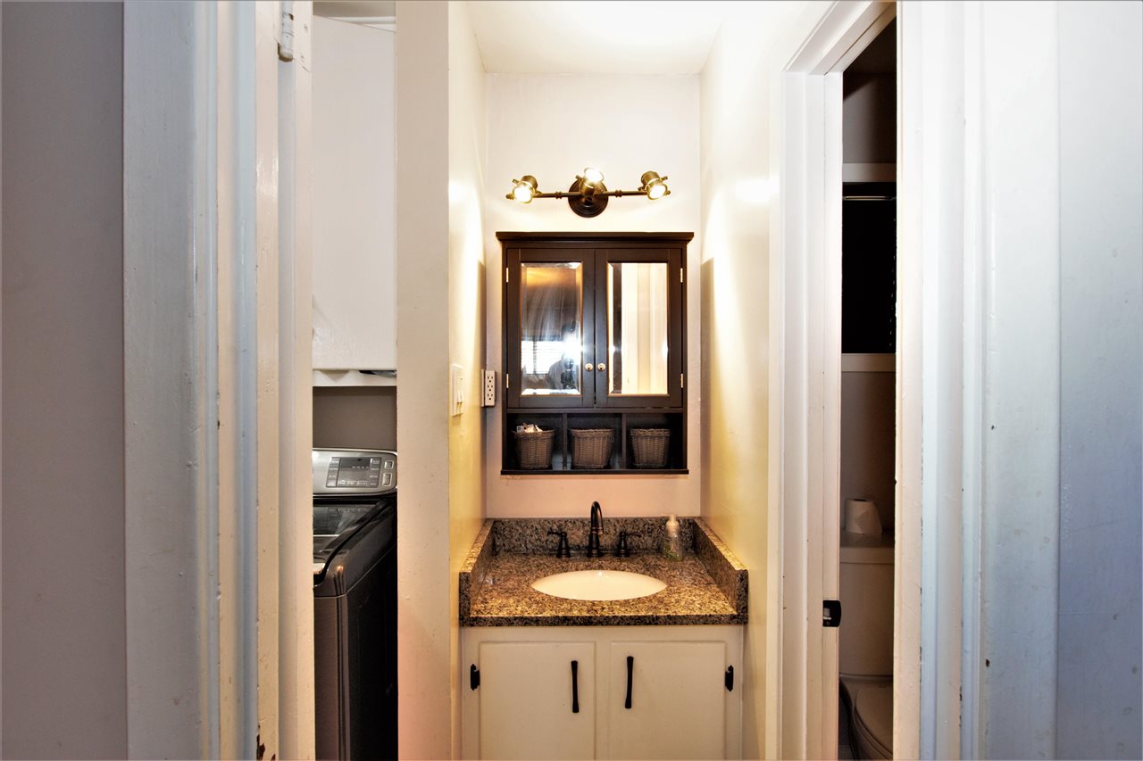 1783 Sea Isle Road Memphis, TN 38117 - Photo 6 of 20 a bathroom with a granite countertop sink and a mirror