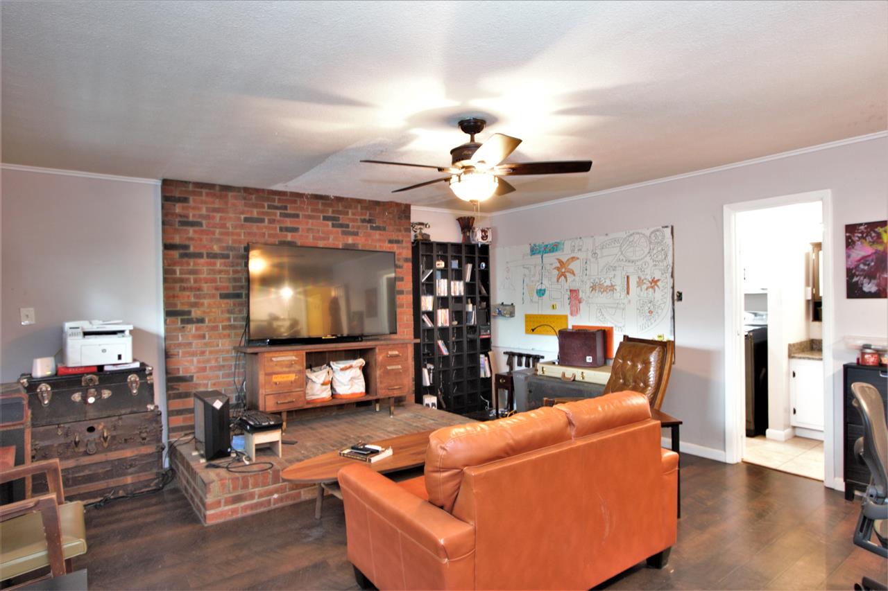 1783 Sea Isle Road Memphis, TN 38117 - Photo 9 of 20 a living room with furniture a fireplace and a flat screen tv