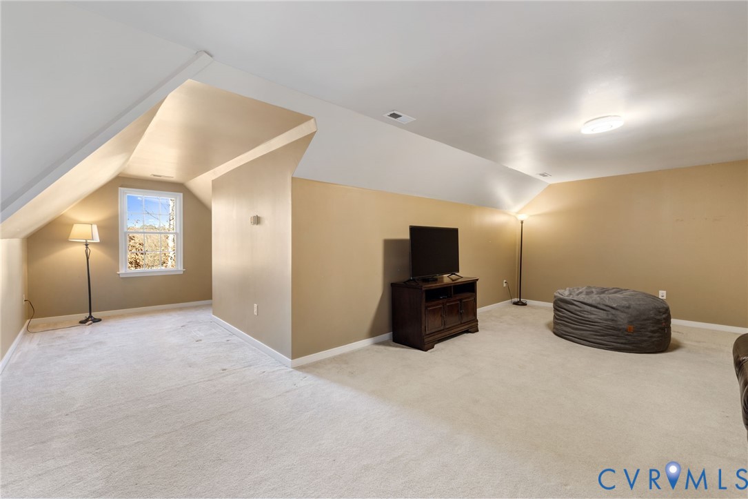 12008 Wheat Ridge Court Glen Allen, VA 23059 - Photo 30 of 36 a living room with furniture and a flat screen tv