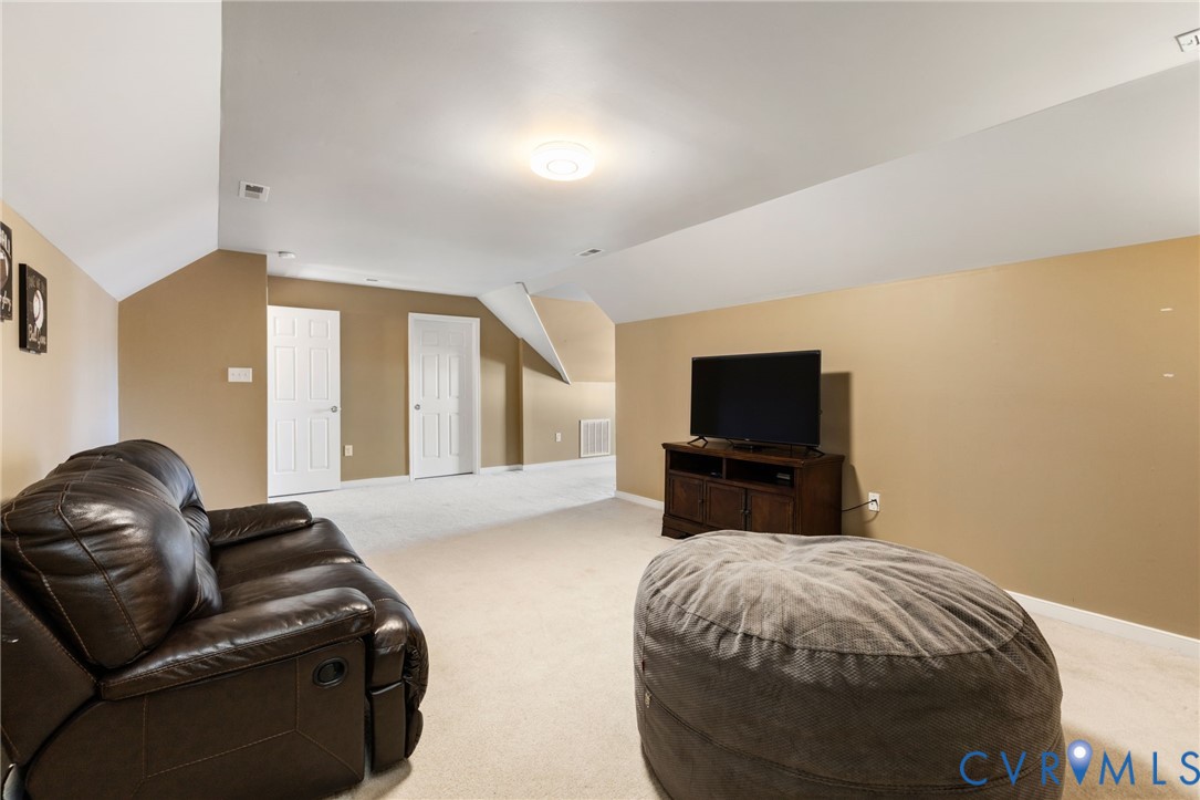 12008 Wheat Ridge Court Glen Allen, VA 23059 - Photo 31 of 36 a spacious bedroom with a bed and a flat screen tv