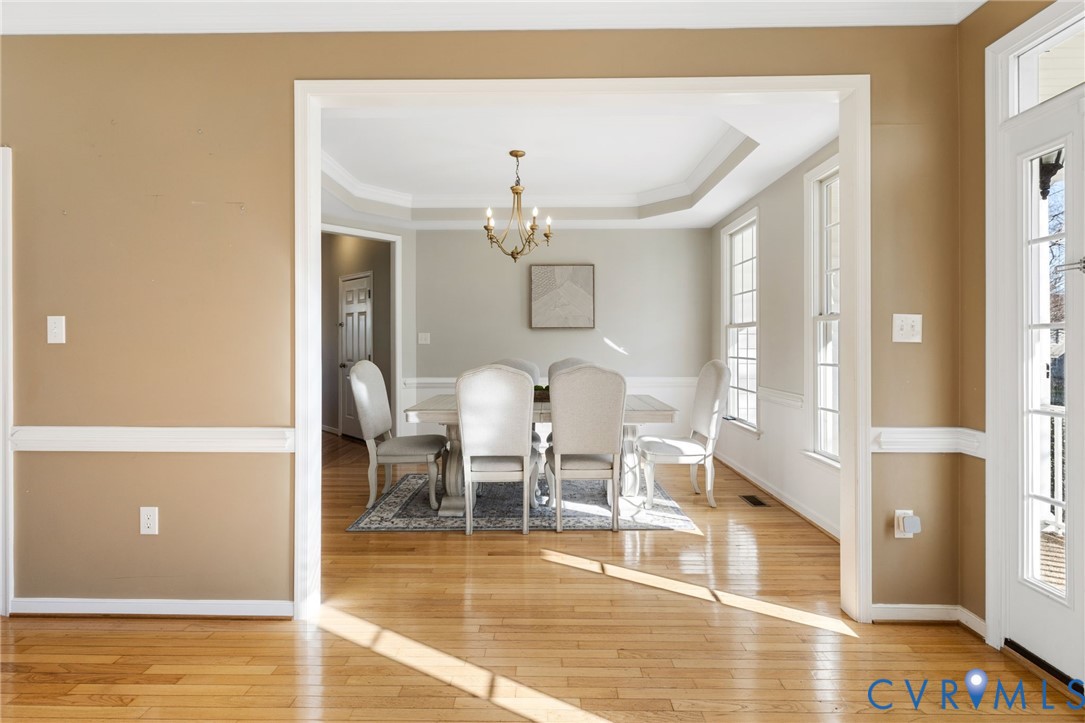 12008 Wheat Ridge Court Glen Allen, VA 23059 - Photo 6 of 36 a view of a dining room with furniture a chandelier and wooden floor