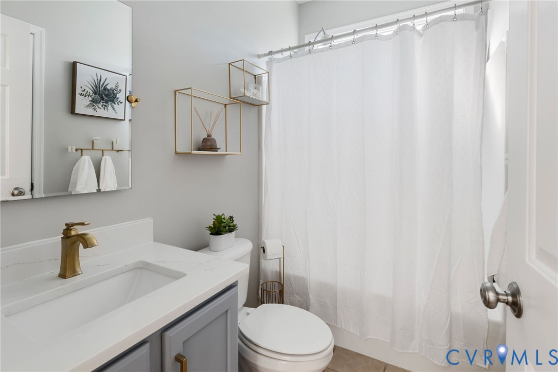 12008 Wheat Ridge Court Glen Allen, VA 23059 - Photo 9 of 36 a bathroom with a sink a toilet and shower curtain