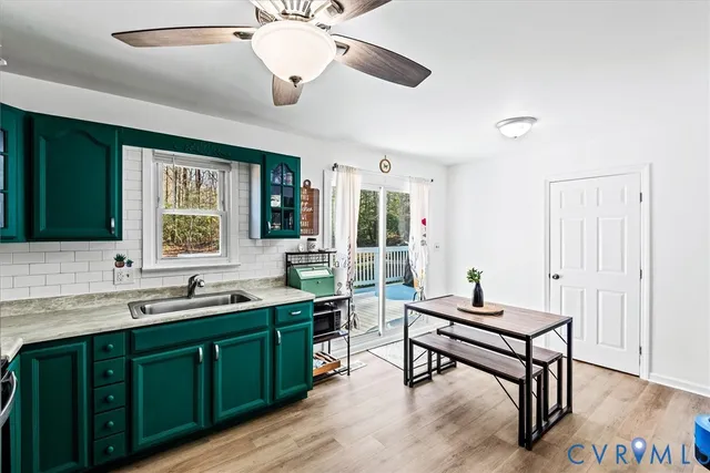 a kitchen with a sink cabinets and wooden floor