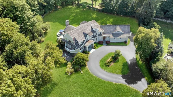 an aerial view of a house with garden space and street view