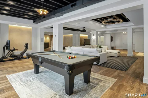 a living room with a table chairs and a table