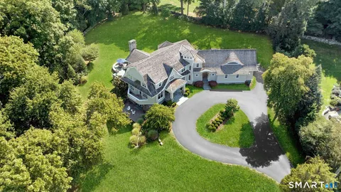 an aerial view of a house with garden space and street view