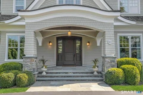 a front view of a house with a garden