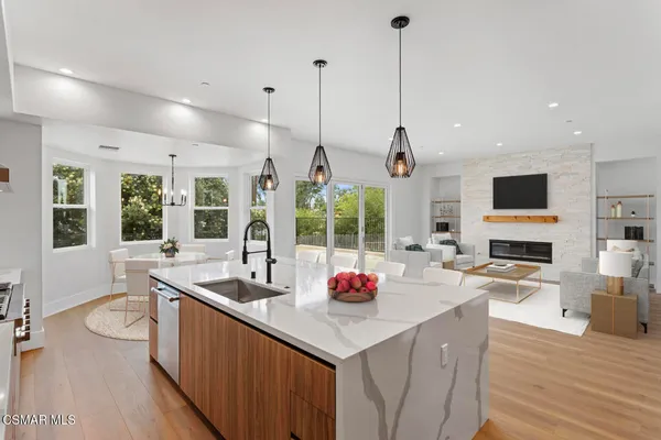 a kitchen with sink a large counter and appliances